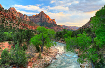 HDR image of the last rays of sun hitting The Watchman with the Virgin River in the foreground in Zion National Park, Utah.